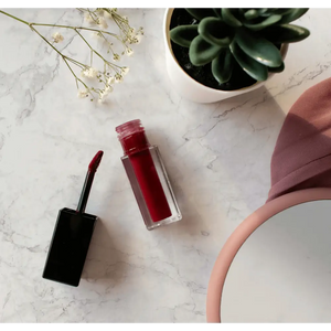 MIANIMED Premium Skincare lipstick and beauty products on marble background with succulent and mirror.
